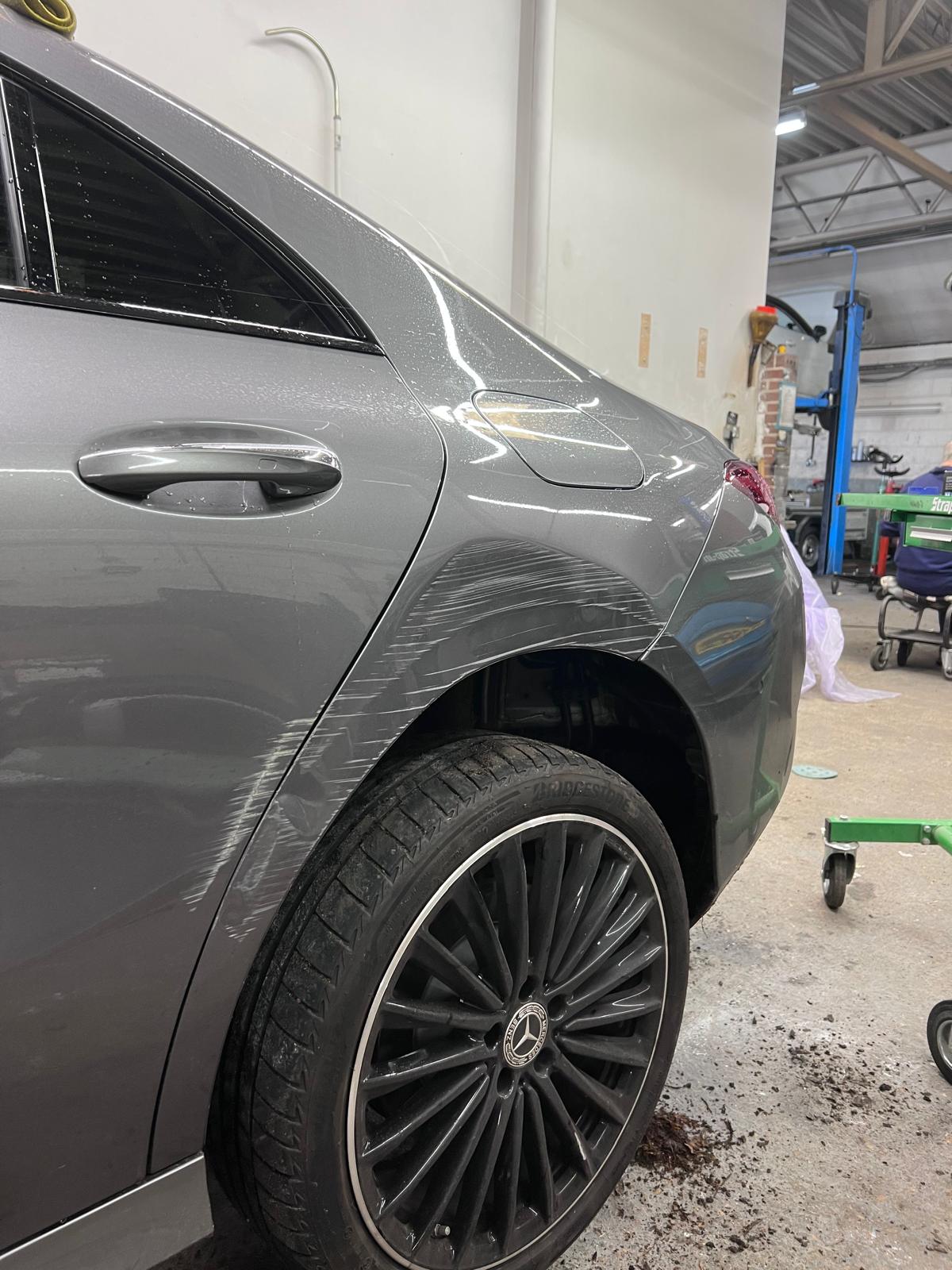 Mercedes CLA rear quarter panel with deep scratches before repair
