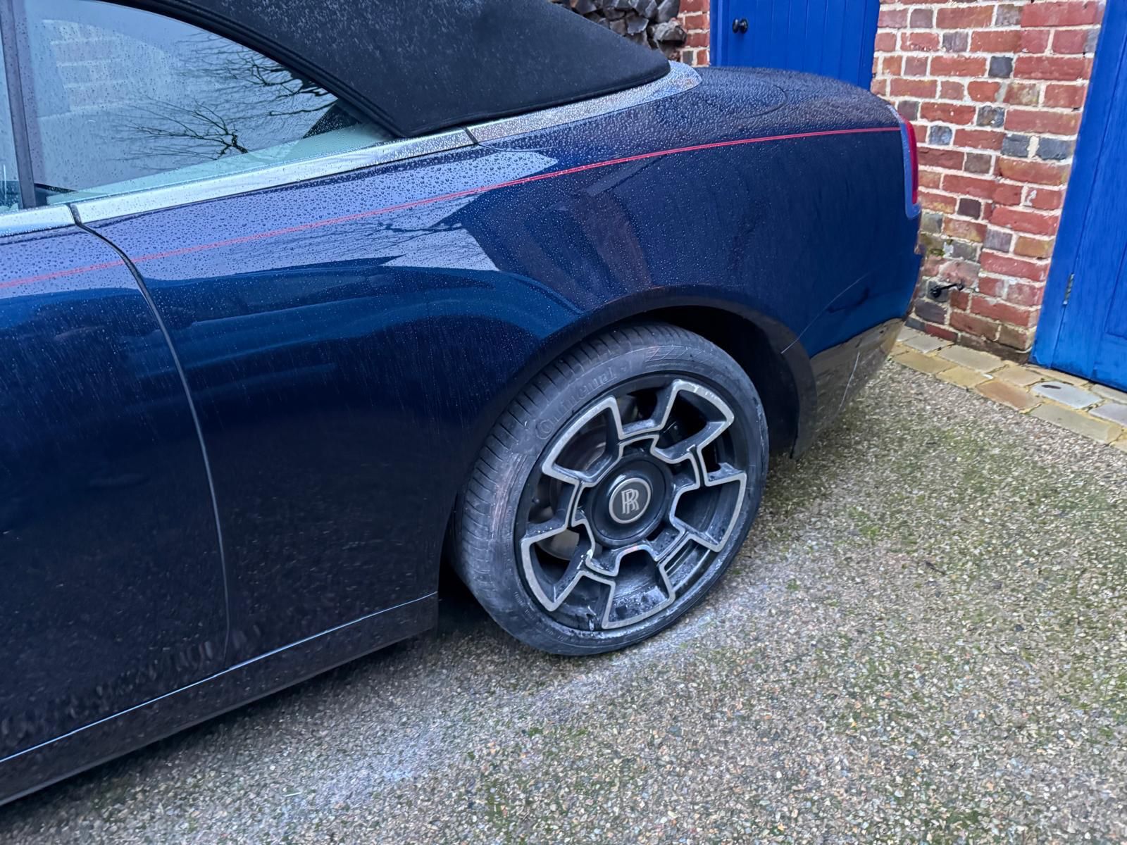 Dark luxury saloon rear quarter polished and resprayed after repair